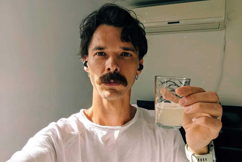 A picture of fetsh holding a glass of muddy liquid