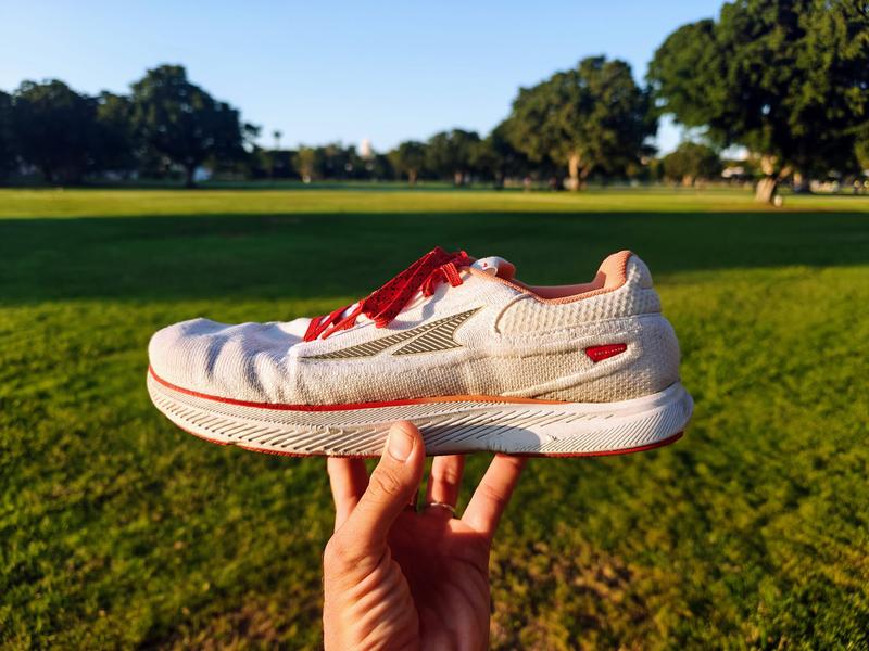 Beautiful photo of Altra Escalante 3 shoe on picturesque background with a vibrant sunset in the distance